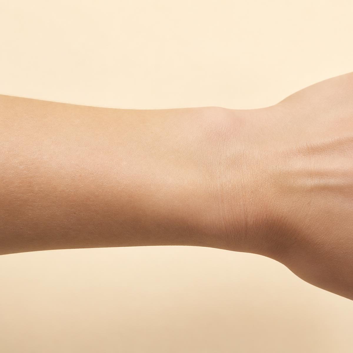 Wrist in porcelain tone, worn with The Regent